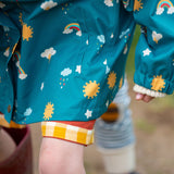 A close up of the print on the Little Green Radicals Child's Rainbow Days print Recycled Waterproof Raincoat