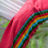 A close up of the stripe detail on the side of the Little Green Radicals Red Organic Cotton Comfy Joggers with rainbow stripe on the sides.