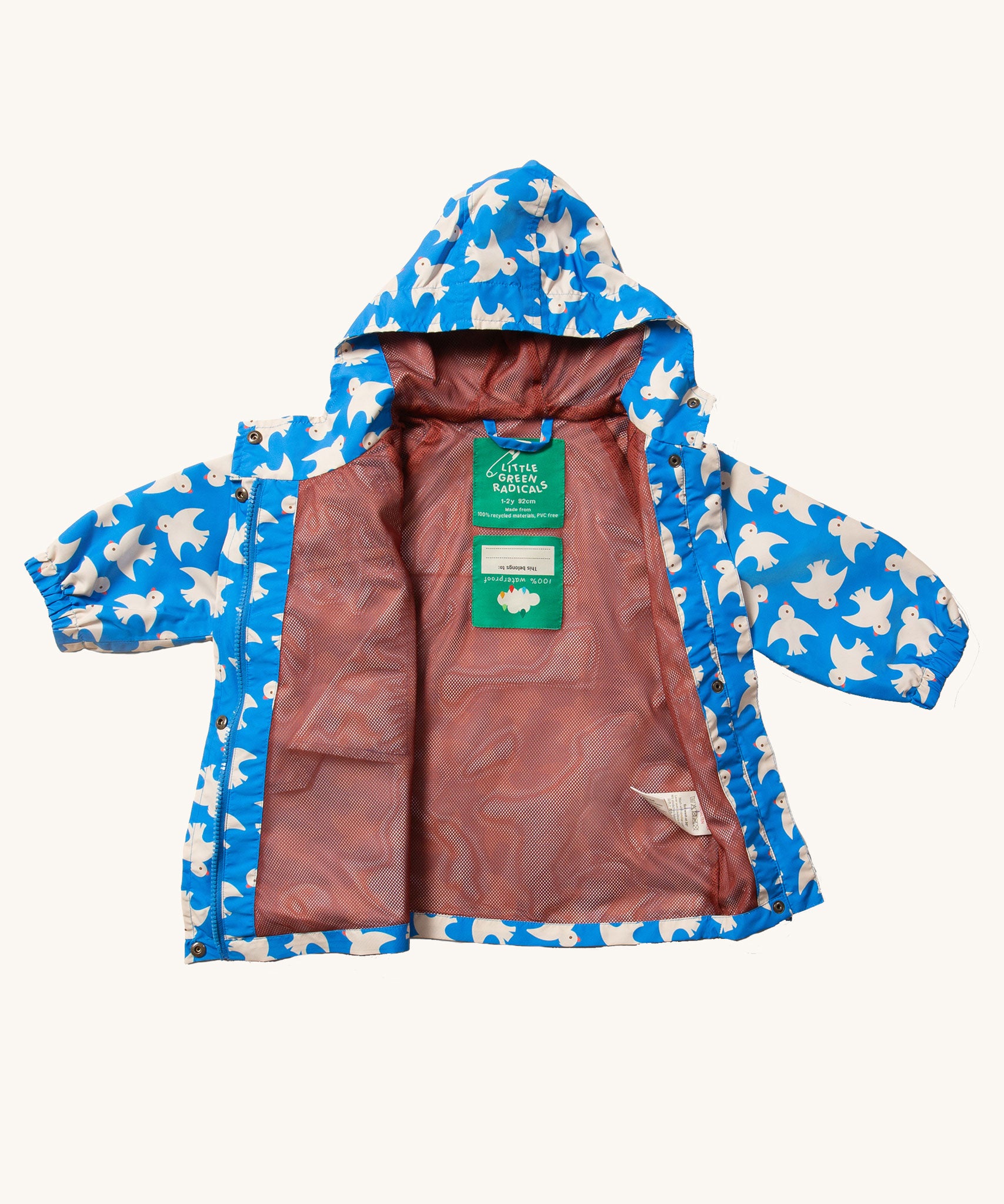 The Little Green Radicals Diving And Splashing Blue Recycled Waterproof Kids Packable Anorak shown with the zip fully unzipped and side folded back showing the red coloured mesh lining inside. 