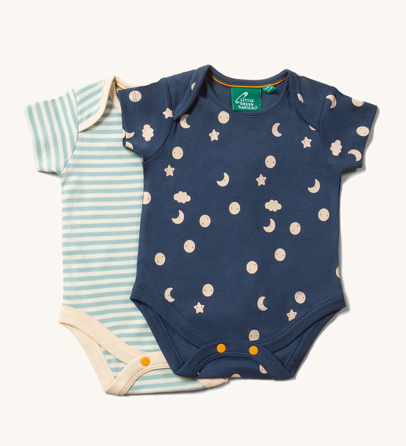 The Little Green Radicals Full Moon Organic Cotton Baby Body Set on a plain background. One body suit has a moon and cloud print on a blue background the second has a cream and blue striped design. 