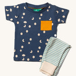 Little Green Radicals Organic Cotton Children's Full Moon T-Shirt & Jogger Set. The T-short has a moon and star print on a dark blue background with a yellow pocket, the joggers have a  blue and off white striped design. 