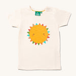 The Little Green Radicals Fun In The Sun Short Sleeve T-Shirt. A yellow coloured sun with rainbow coloured triangle shaped rays on an off white coloured organic cotton t-shirt.