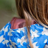 A close up of the hood Little Green Radicals Diving And Splashing Blue Recycled Waterproof Kids Packable Anorak, showing the red mesh lining.