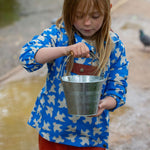 A front view of a child wearing the Little Green Radicals Diving And Splashing Blue Recycled Waterproof Kids Packable Anorak.