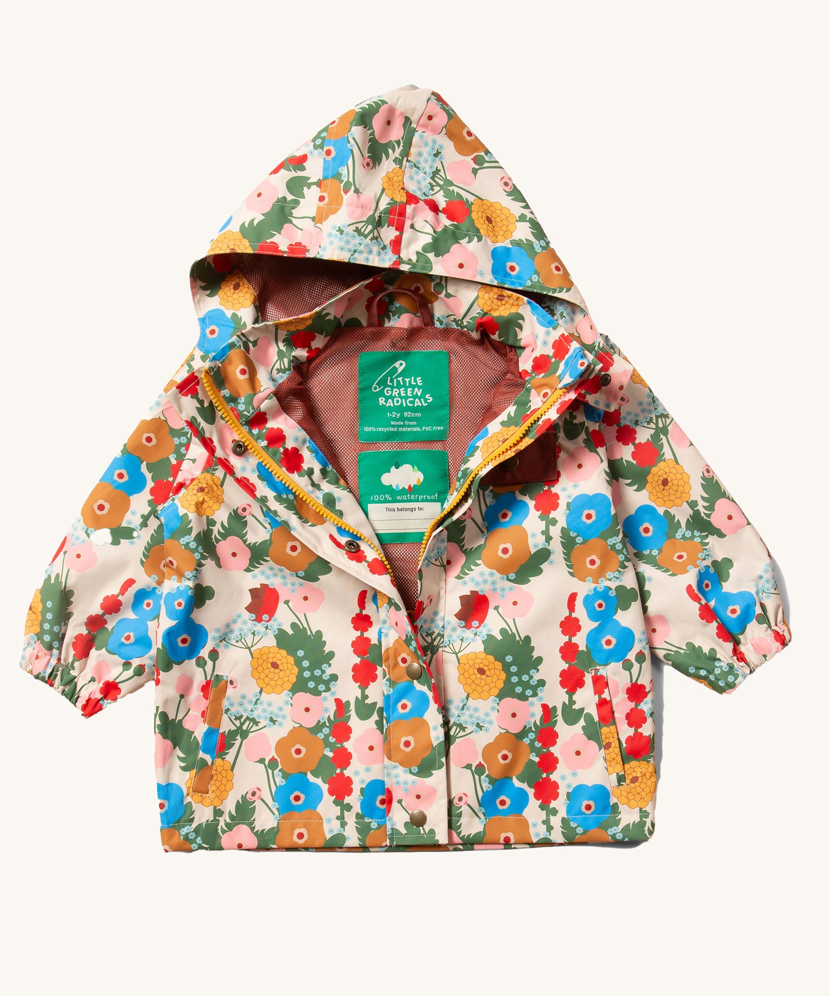 The Little Green Radicals Child's Flora & Fauna vintage style flower print Waterproof Raincoat with the zip opened slightly reveling the rest rust coloured mesh lining inside.