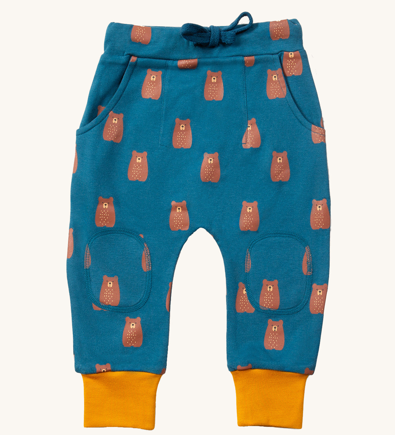 Little Green Radicals Organic Cotton Kids Comfy Joggers with a brown Teddy Bears print on a blue coloured background. The joggers have yellow gold coloured cuffs.