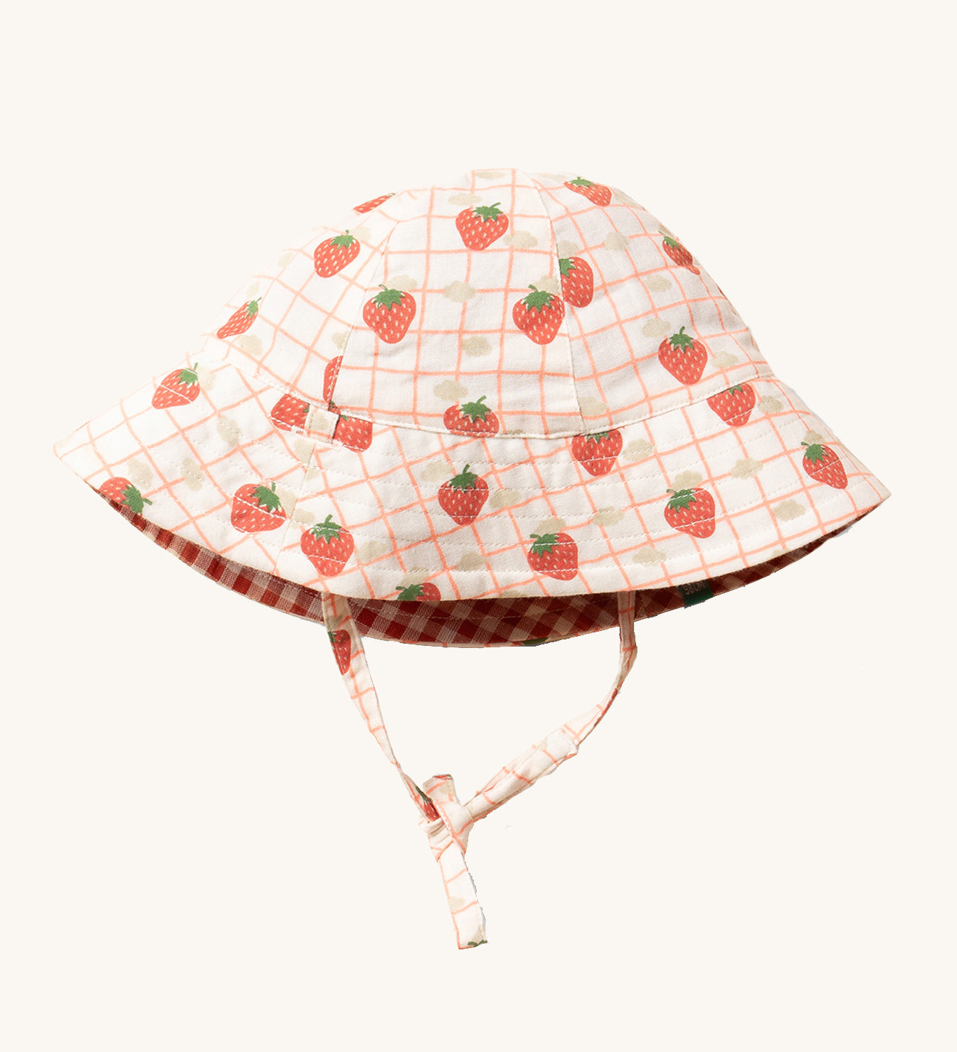 Little Green Radicals Strawberry Days Reversible Kids Sun Hat. The side with the strawberry print on a cream background is shown.