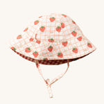 Little Green Radicals Strawberry Days Reversible Kids Sun Hat. The side with the strawberry print on a cream background is shown.