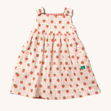 Little Green Radicals Child's Organic Cotton Strawberry Days Reversible Pinny Dress shown with the strawberry print on the outside.