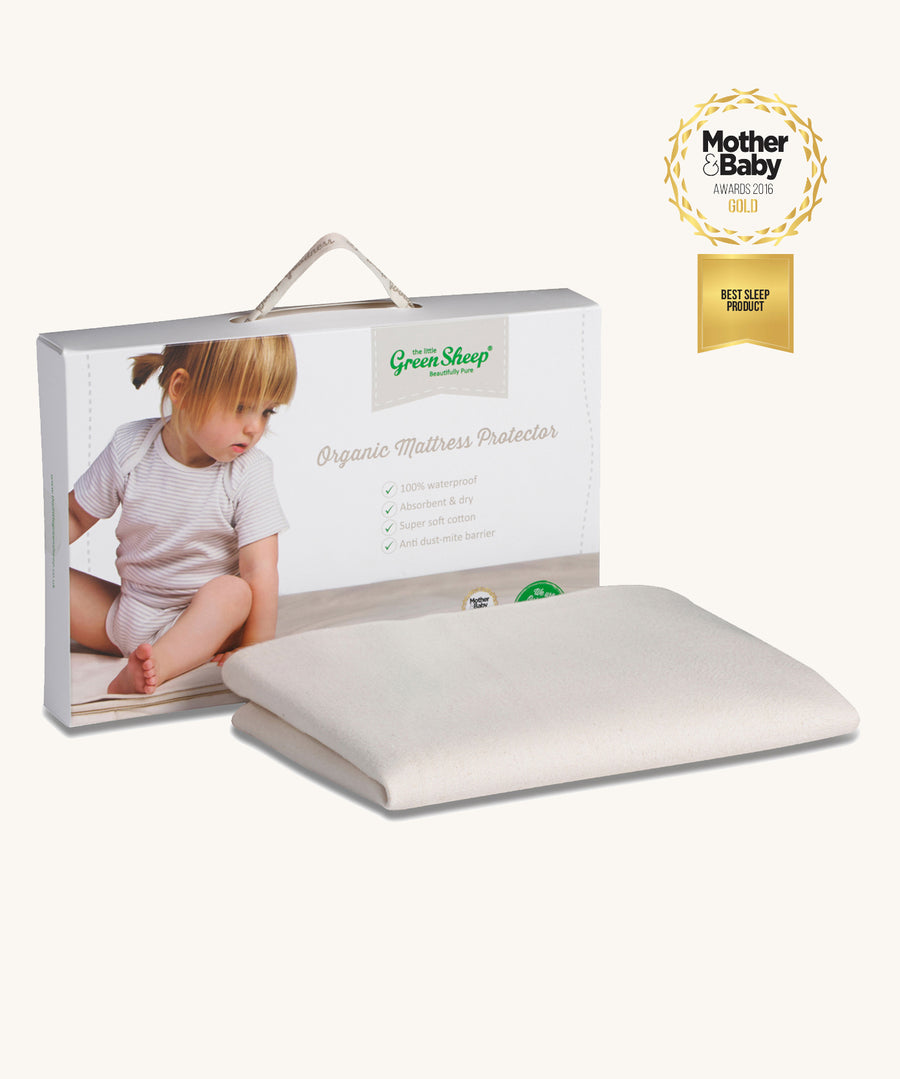 A Little Green Sheep Organic Crib Mattress Protector pictured in packaging on a plain background