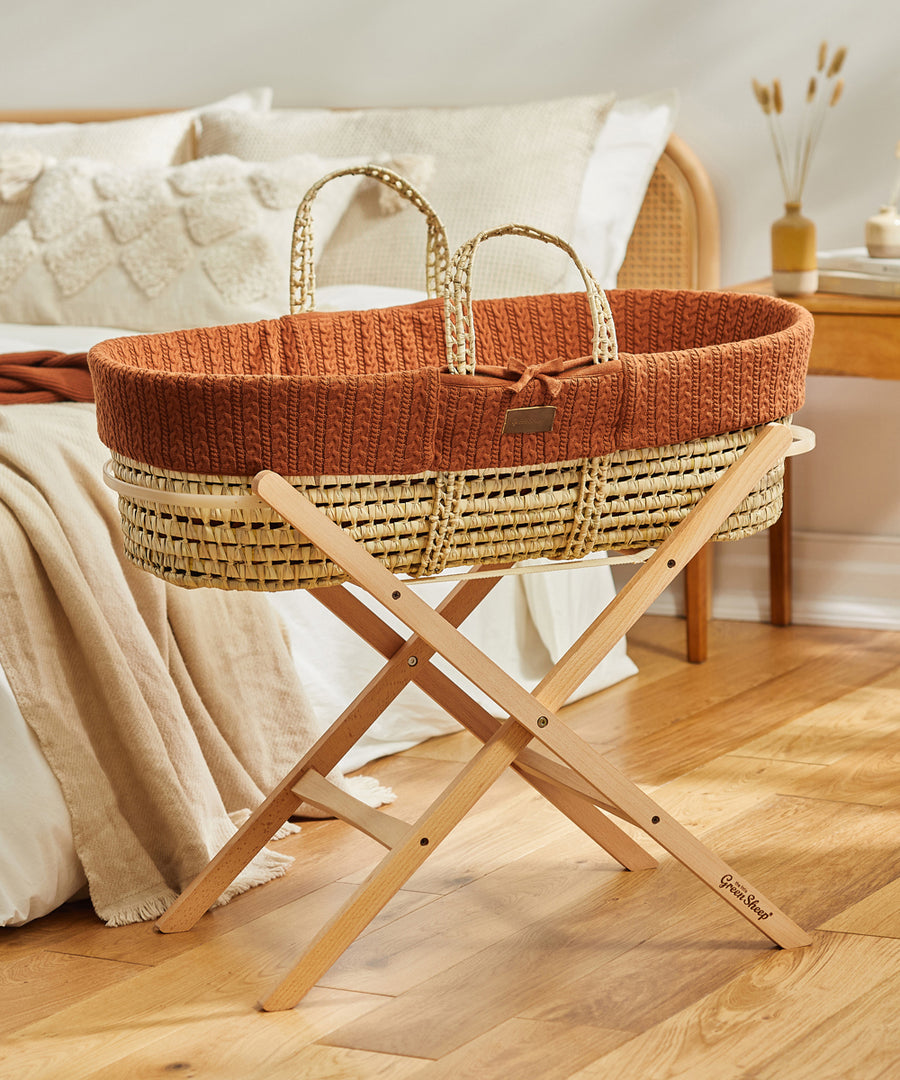 Little Green Sheep Organic Knitted Moses Basket & Mattress in terracotta orange on a folding stand which is available separately 