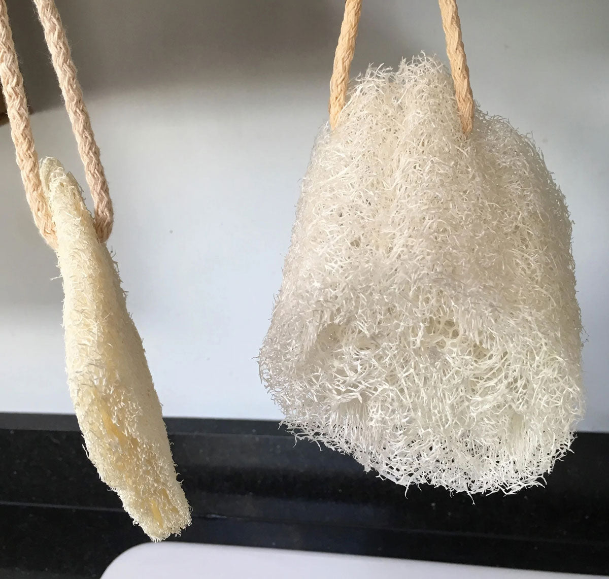 two LoofCo Loofah Washing-Up Pads hanging up