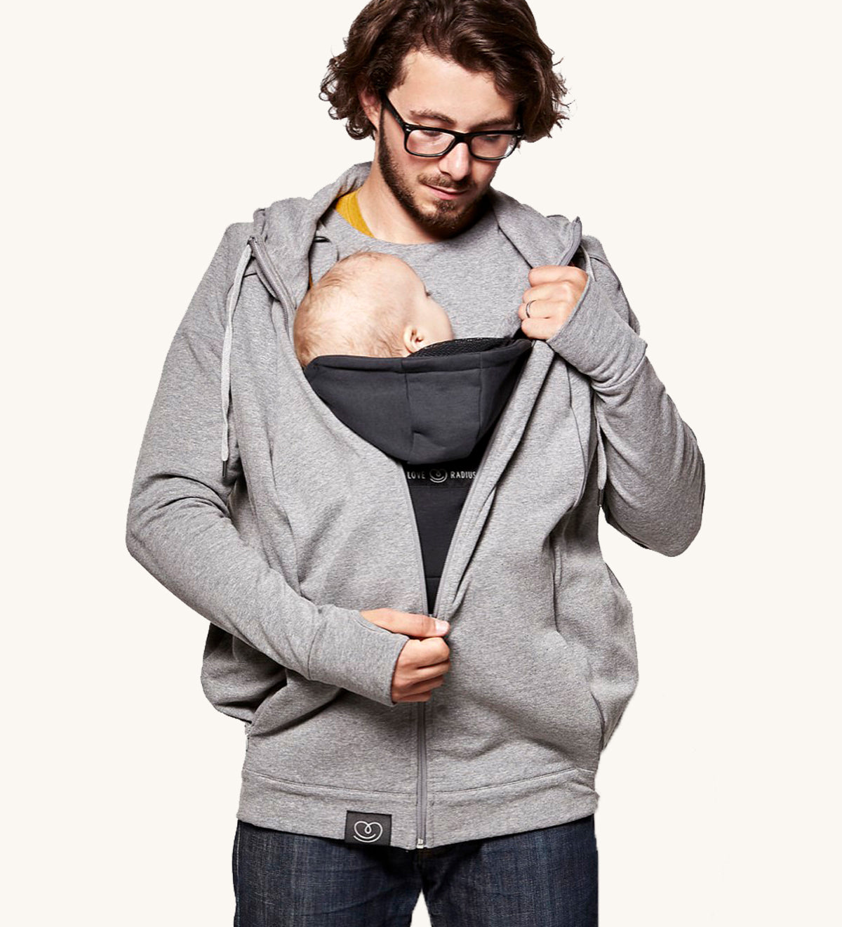 An adult wearing the Love Radius Parents Hoodie In Heather Grey, with a child inside showing the wrap-over chest cover. On a cream background