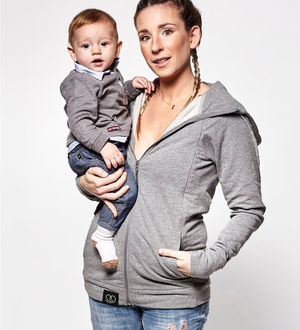  with a child inside showing the wrap-over chest cover. On a cream background