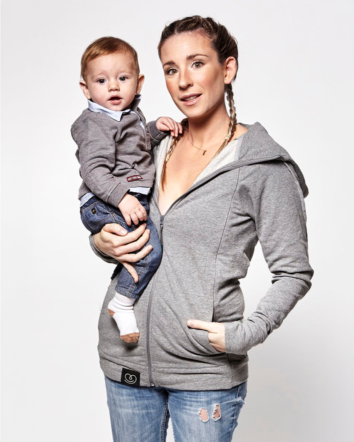  with a child inside showing the wrap-over chest cover. On a cream background