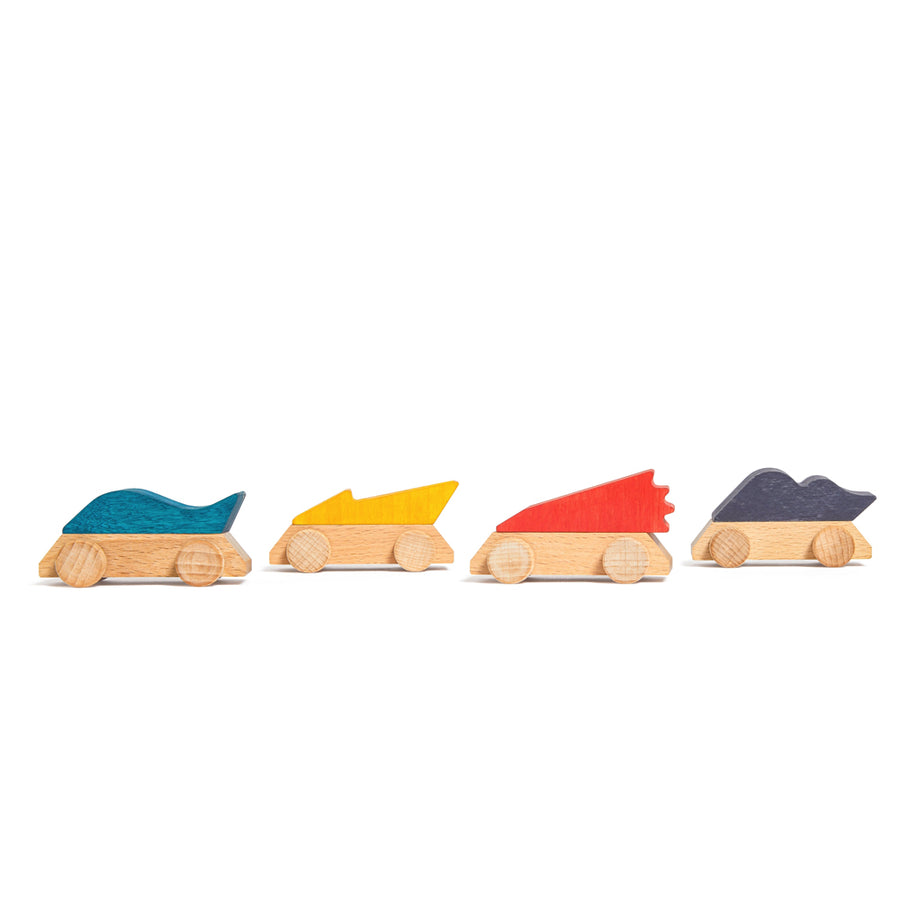 4 Lubulona handmade coloured car toys lined up in a row on a white background