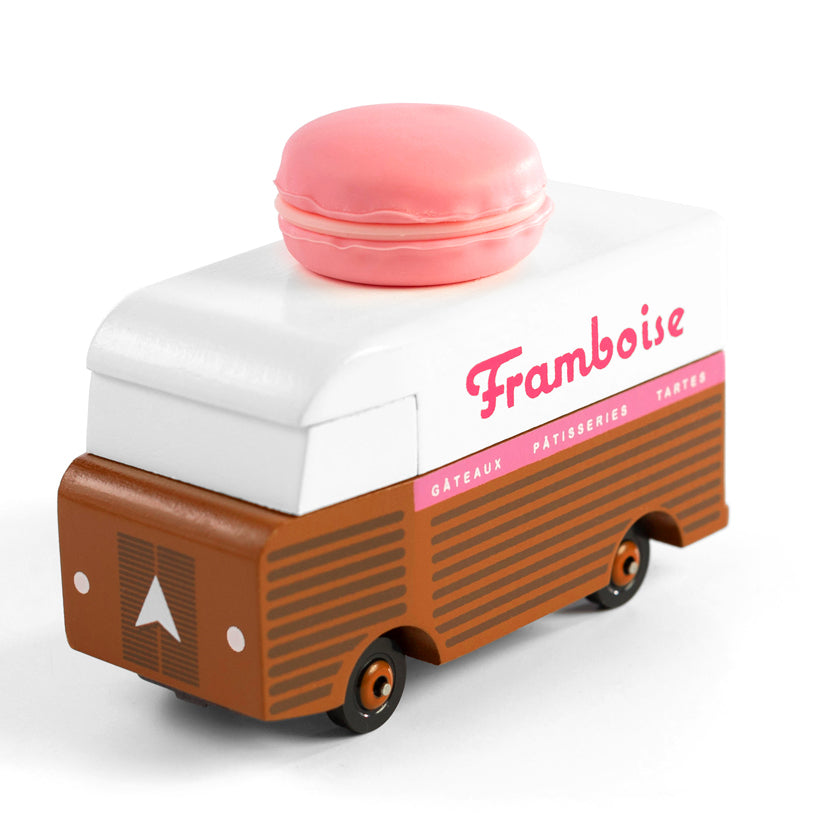 Picture of the Framboise Candylab Candyvan. It is a 1960s style brown and white van with a pink Raspberry Macaron on the roof.