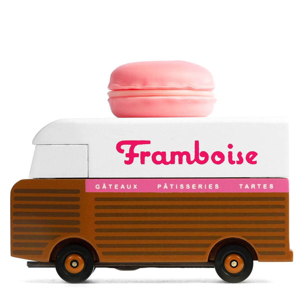 Picture of the Framboise Candylab Candyvan. It is a 1960s style brown and white van with a pink Raspberry Macaron on the roof.