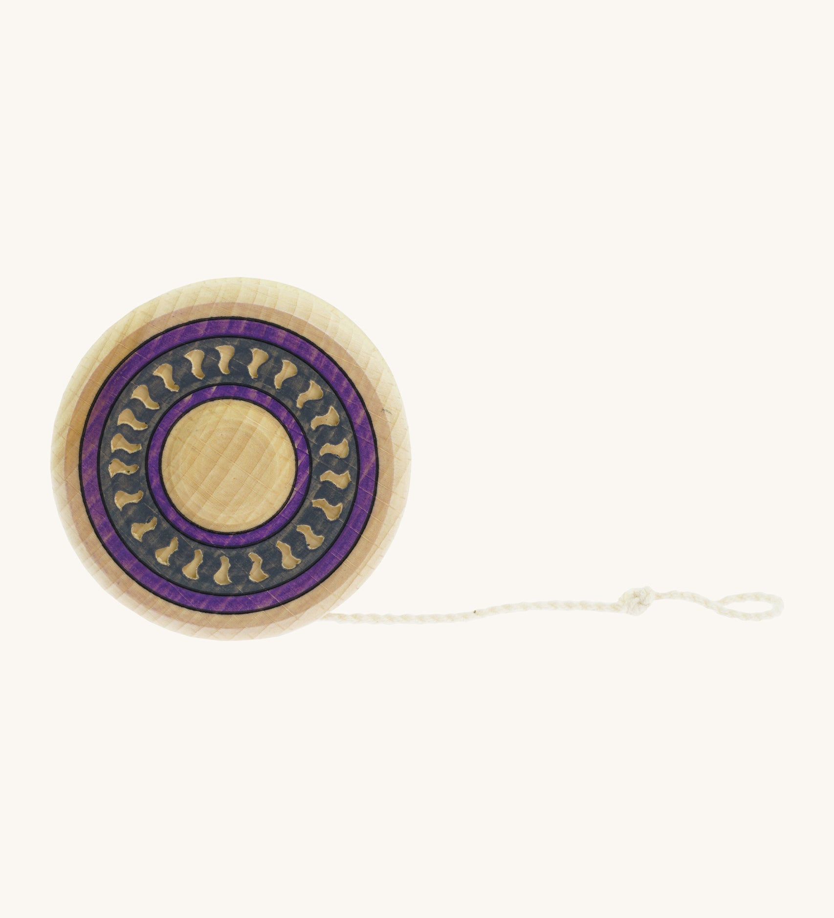 A wooden Mader Arabesk freewheel yo yo with a purple and blue trim design on  a cream background.