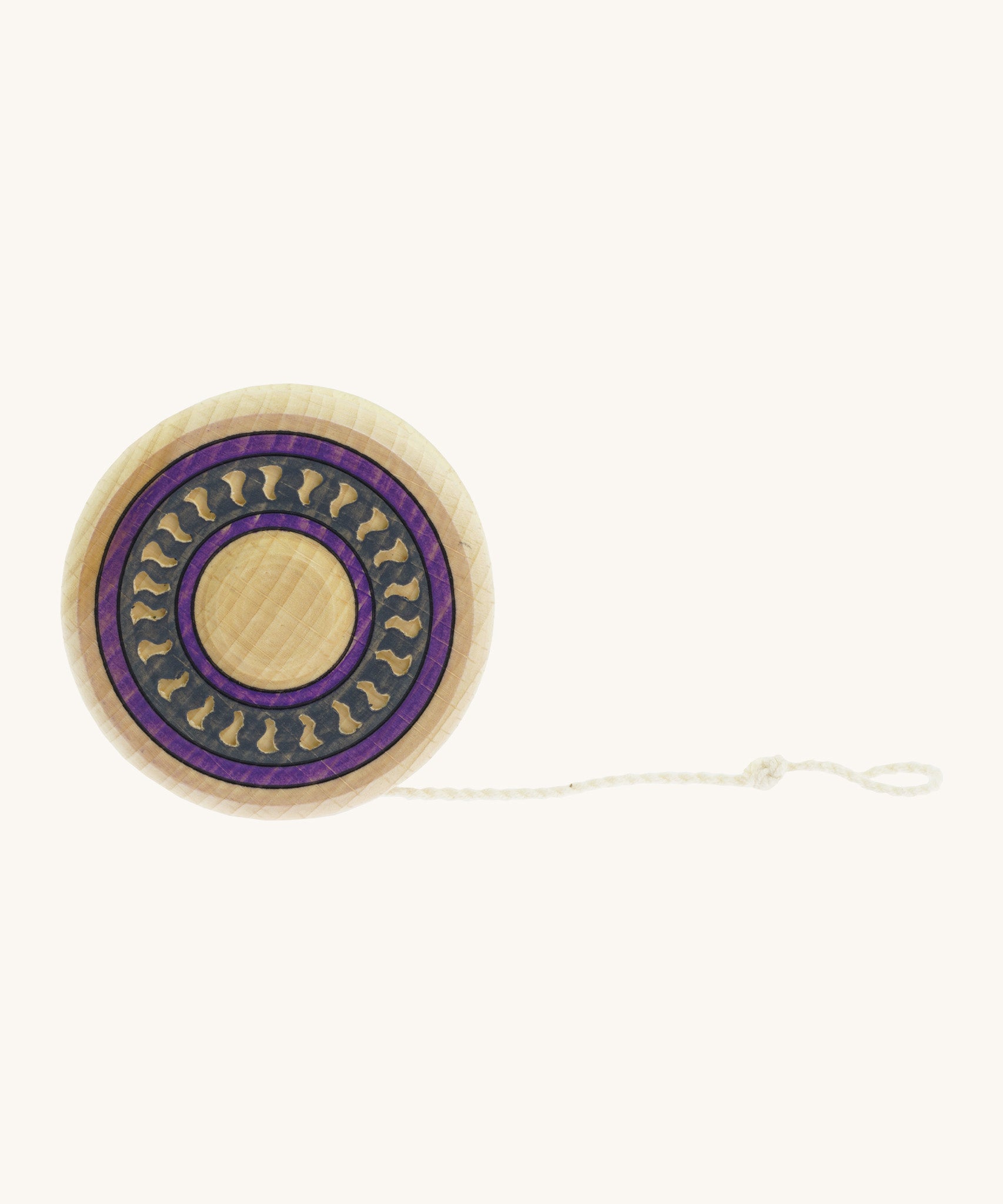 A wooden Mader Arabesk freewheel yo yo with a purple and blue trim design on  a cream background.