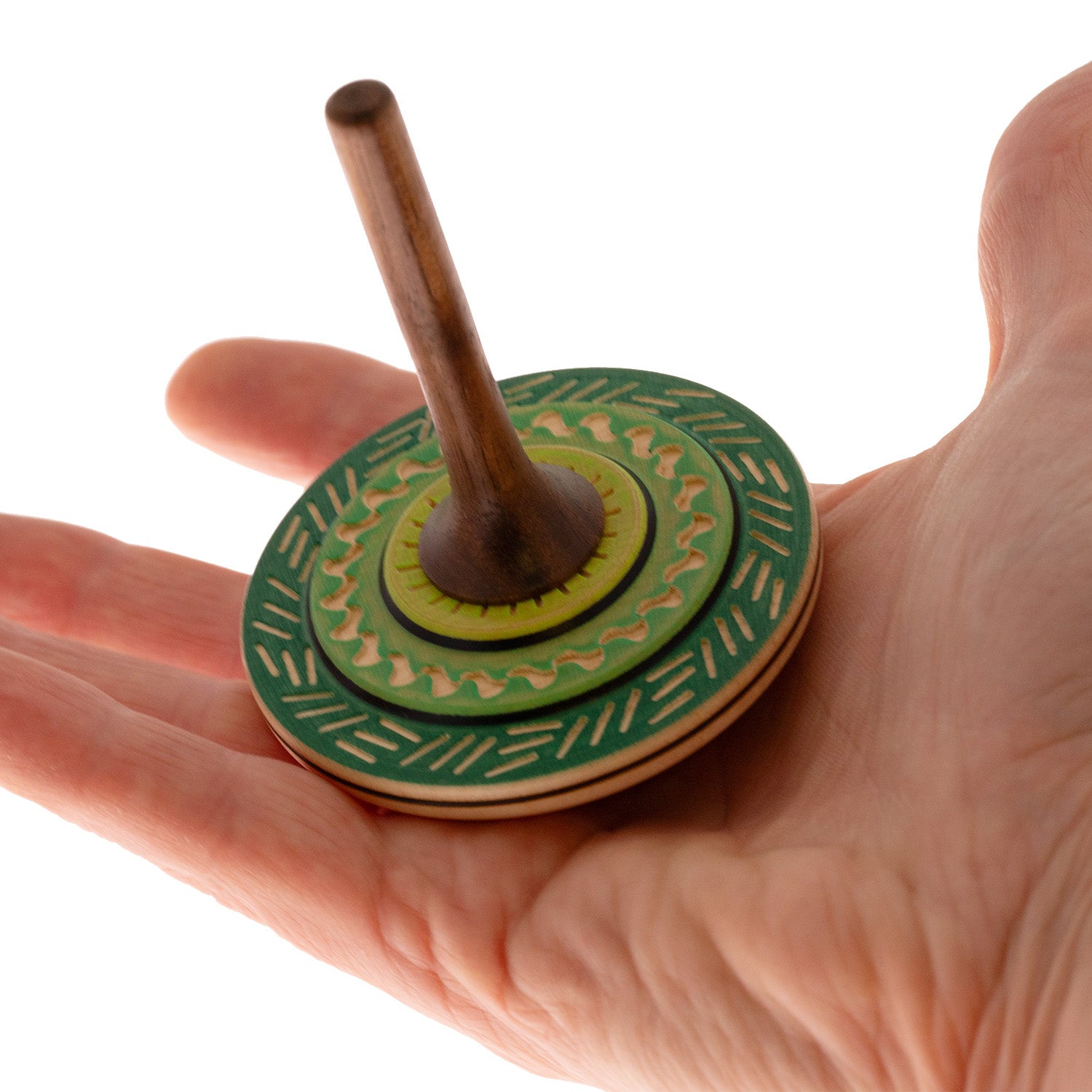 Mader Bonbon Spinning Top sitting on an adult hand against a plain background.