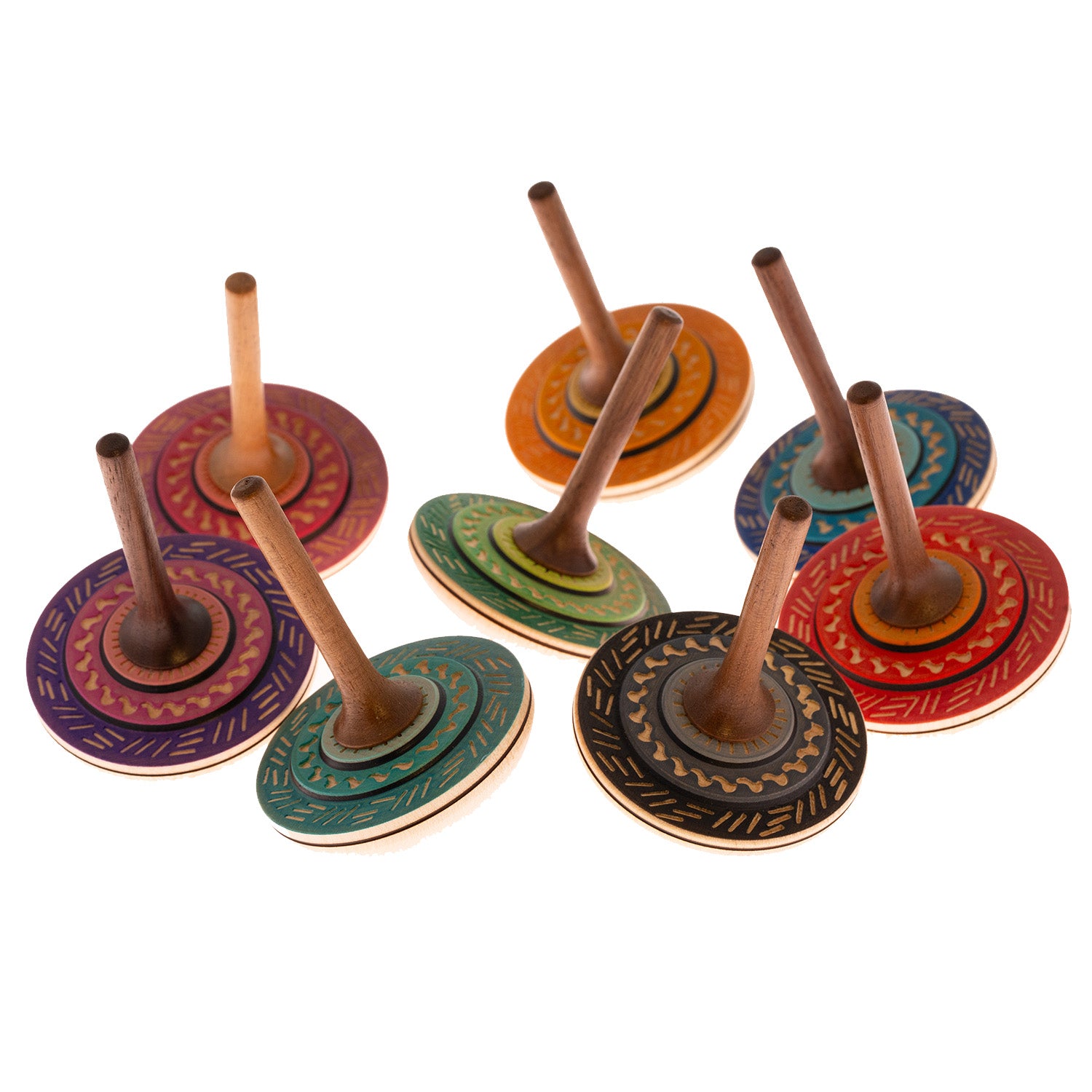 Multiple different coloured Mader Bonbon Spinning Tops on a plain background.