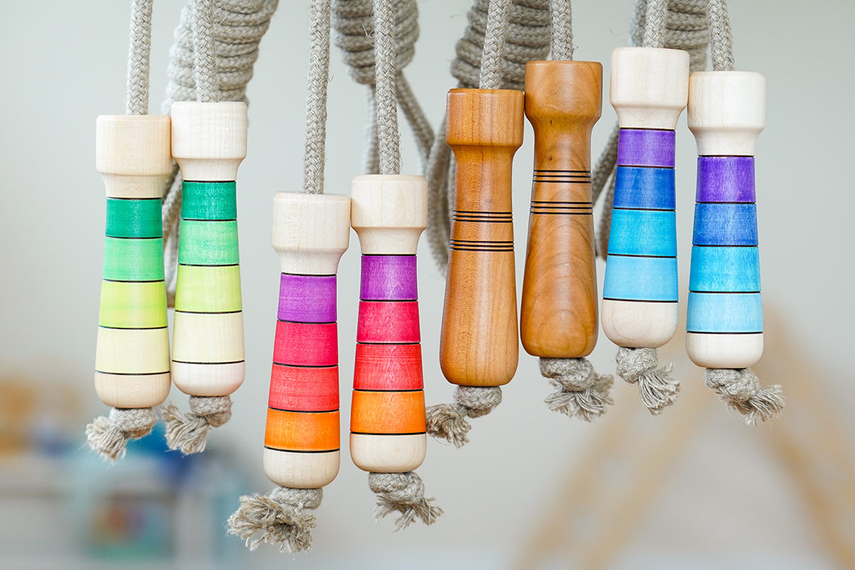 Made eco-friendly linen skipping ropes hanging in front of a grey background