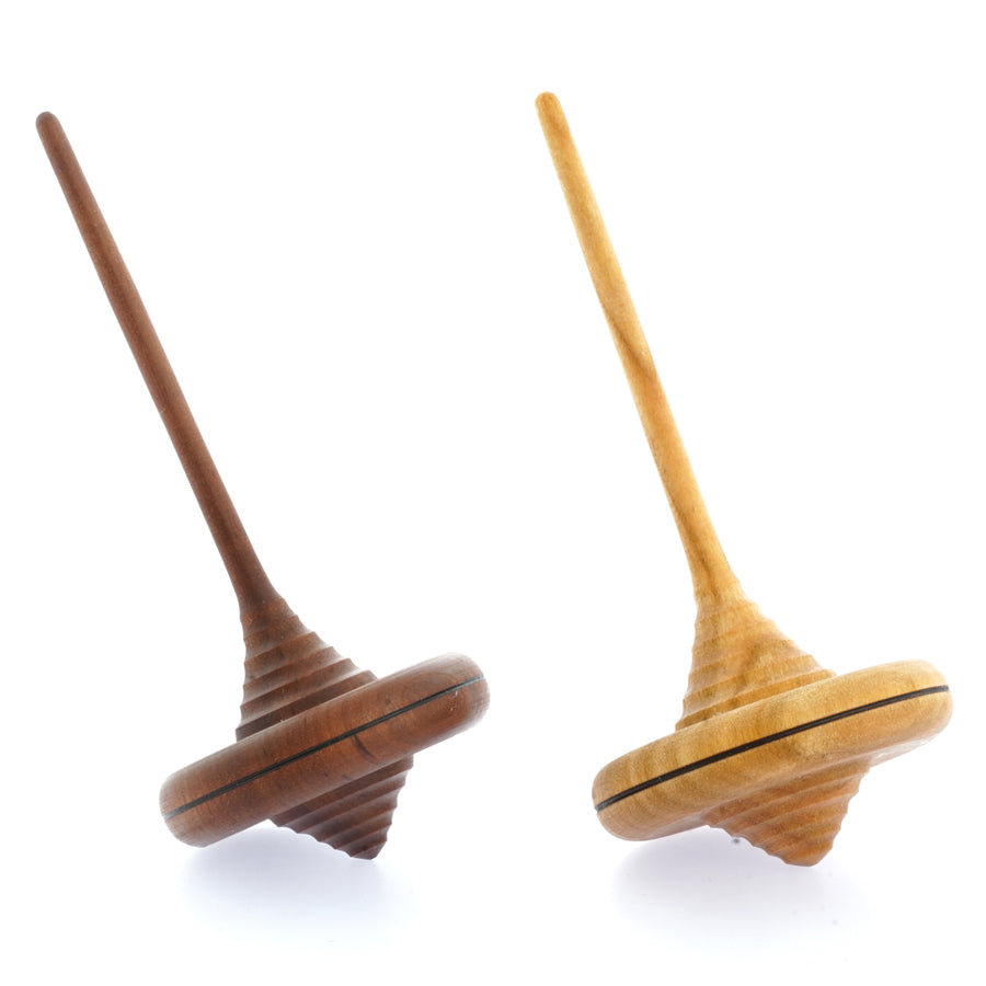 Mader wooden Ibis spinning tops in the light and dark wood variations on a white background