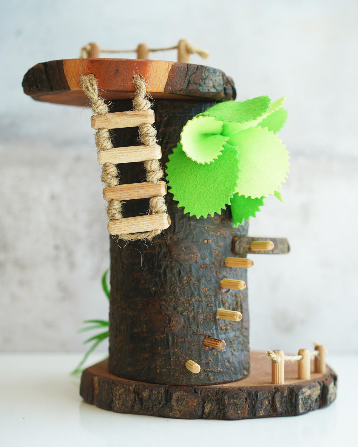 Close up of the back of the Magic Wood Tree Cave showing the wooden rope ladder detail and green felt plant