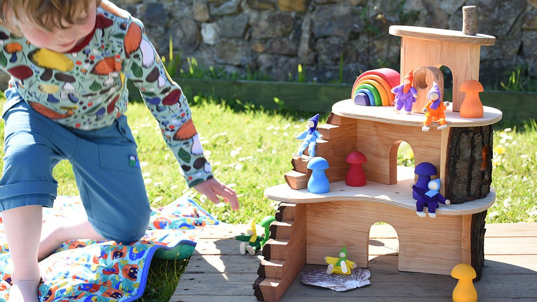 Child playing with the Magic Wood wooden fairy house