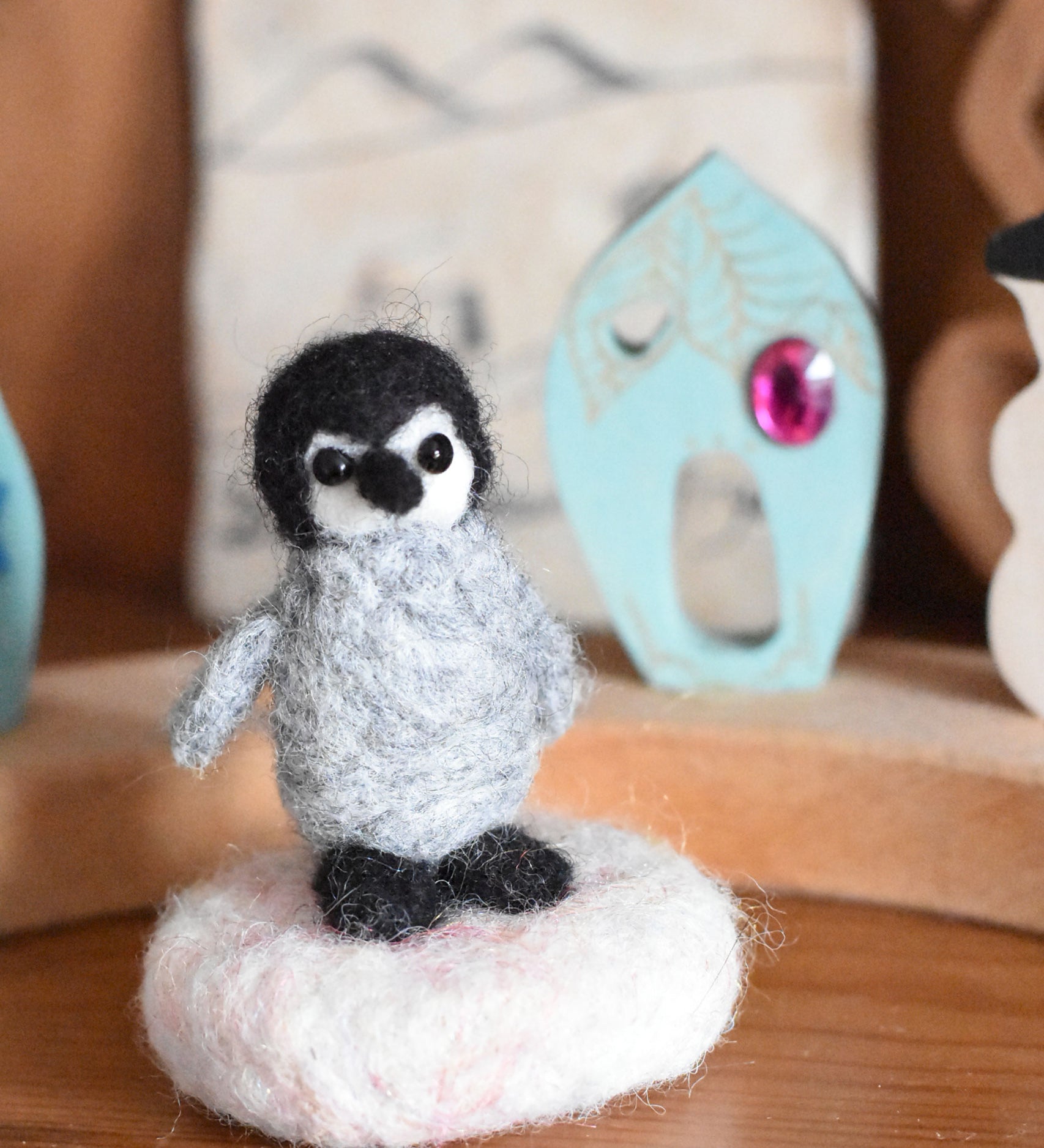 A small felted penquin figure created using The Makerss  Amiguwoolli Penguin Mini Needle Felt Kit. 