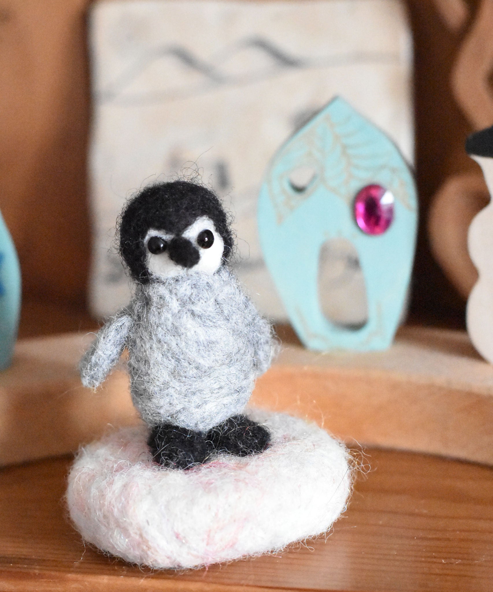 A small felted penquin figure created using The Makerss  Amiguwoolli Penguin Mini Needle Felt Kit. 