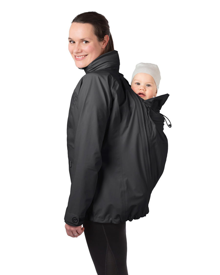 A person wearing the Mamalila Outdoor Explorer Babywearing Jacket - Black