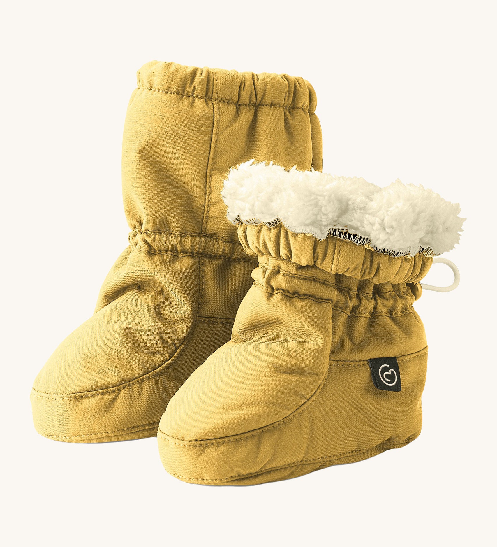 Mamalila eco-friendly winter allrounder baby booties in the mustard colour on a cream background