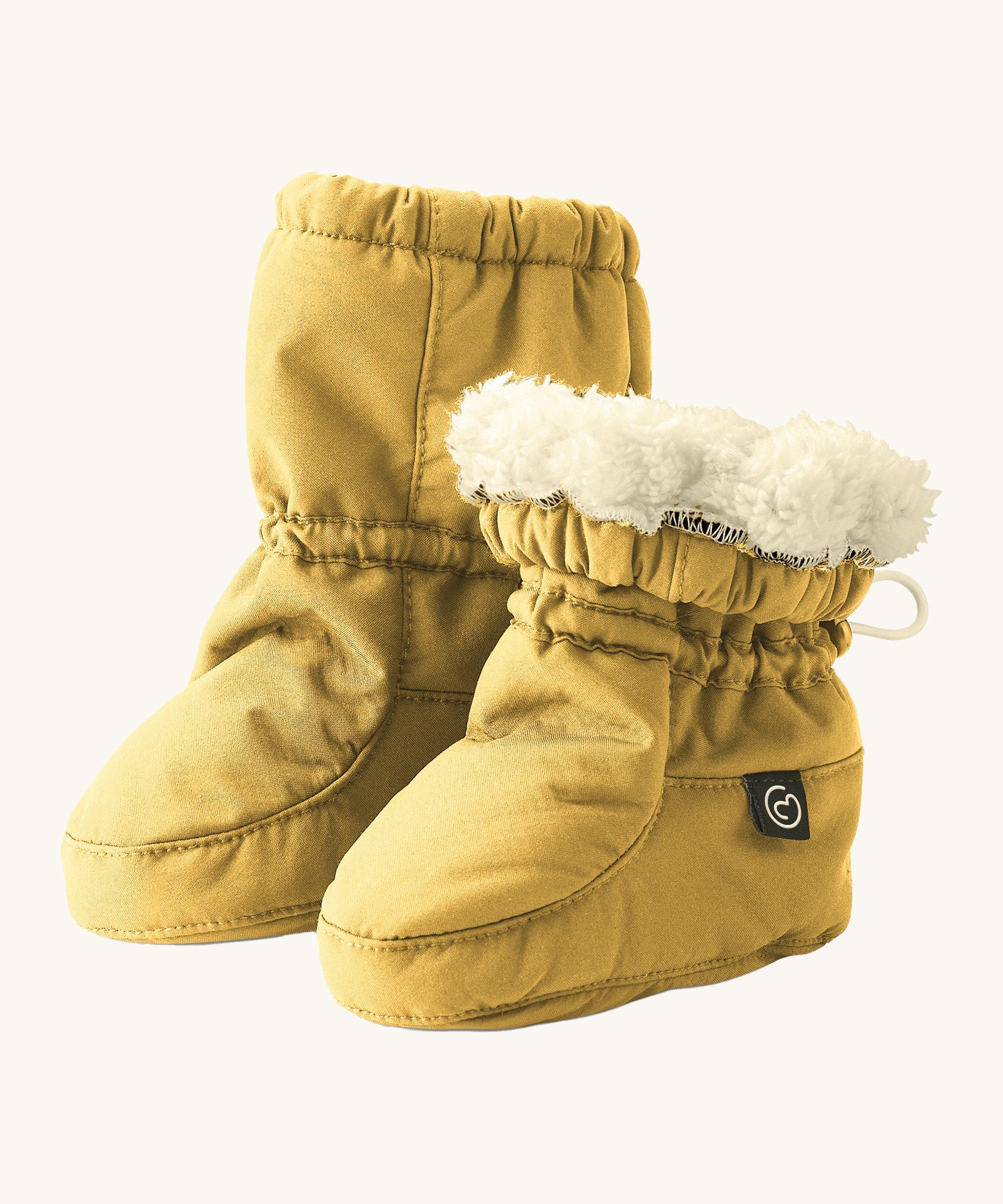 Mamalila eco-friendly winter allrounder baby booties in the mustard colour on a cream background