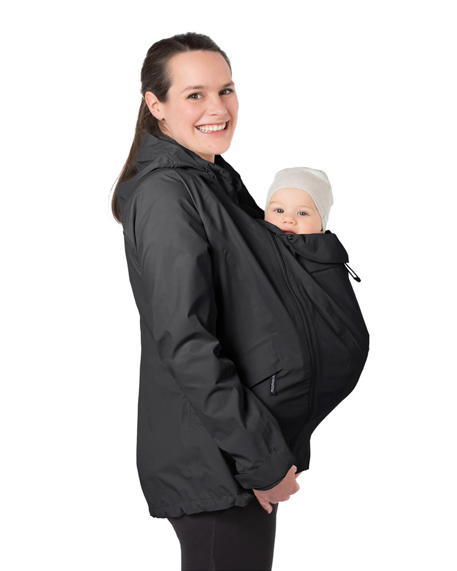 A person wearing the Mamalila Outdoor Explorer Babywearing Jacket - Black