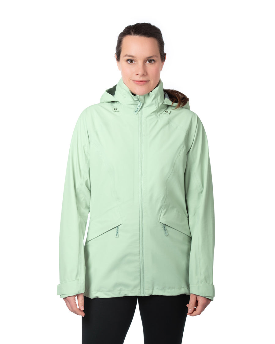 A person wearing the Mamalila Outdoor Explorer Babywearing Jacket - Mint