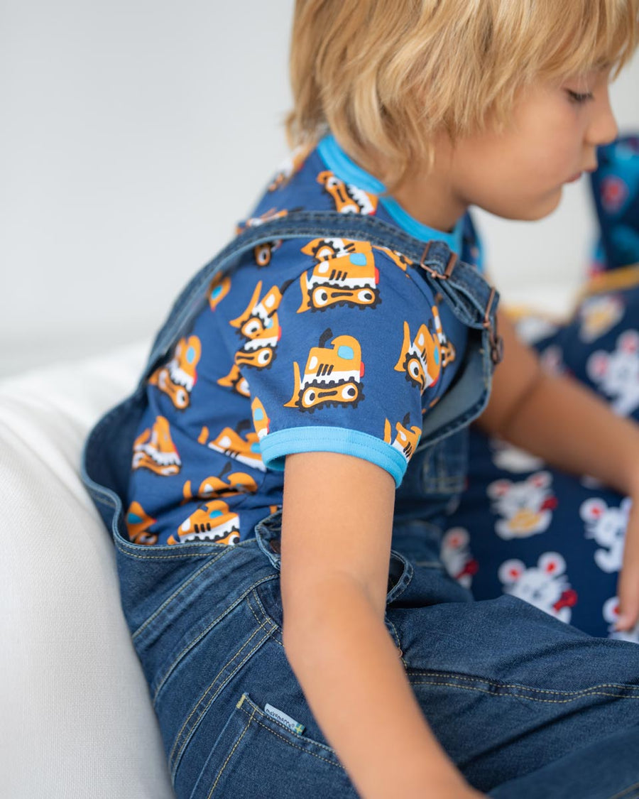 Close up of boy wearing the Maxomorra bulldozer short sleeve top under the navy denim dungarees