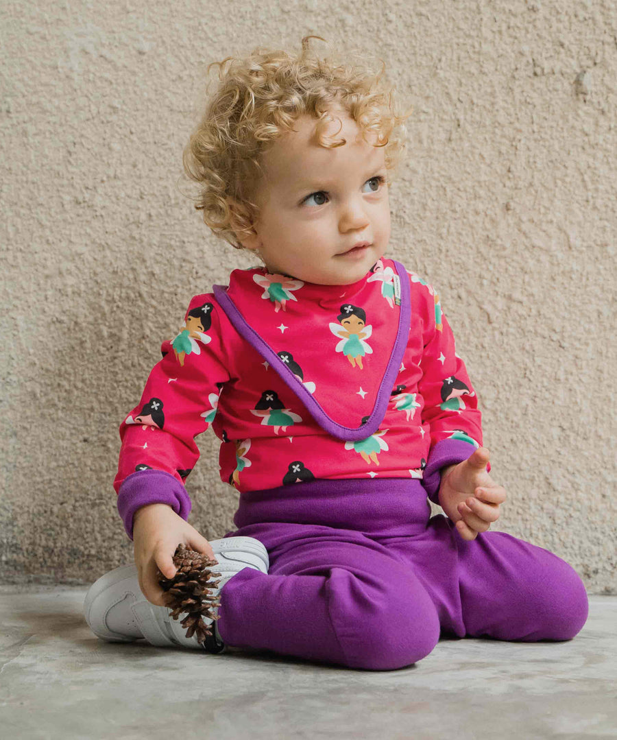 A baby wearing the Maxomorra Fairy print long sleeve bodysuit with a matching bib.  