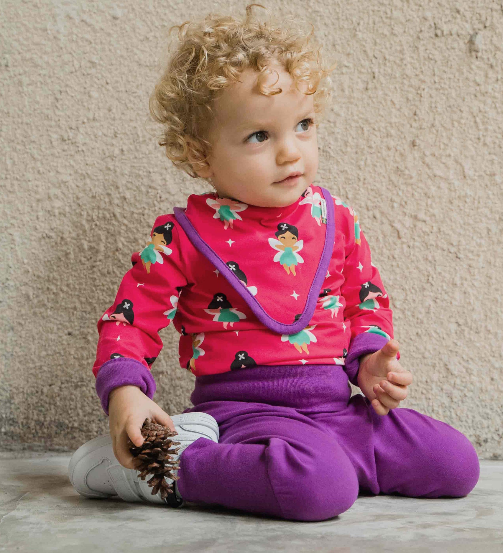 A baby wearing the Maxomorra Fairy print long sleeve bodysuit with a matching bib.  