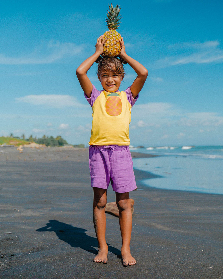 A child playing on a beach with their friends