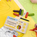 Children's hands using the Medenka junior beeswax crayons to colour in.