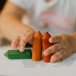 A small child holding Medenka's chunky beeswax crayons for little kids. 