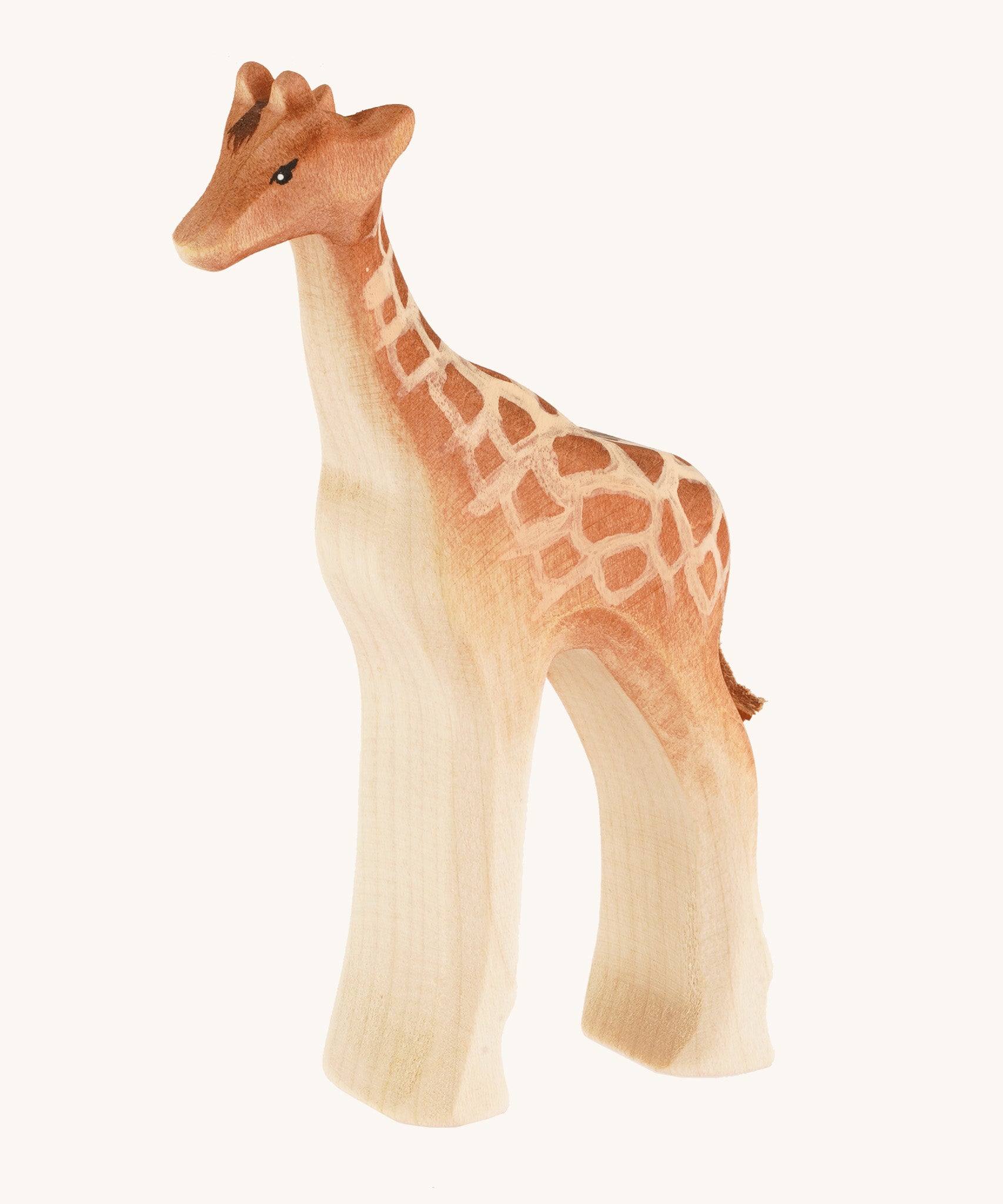 Bumbu wooden standing female giraffe on a cream background