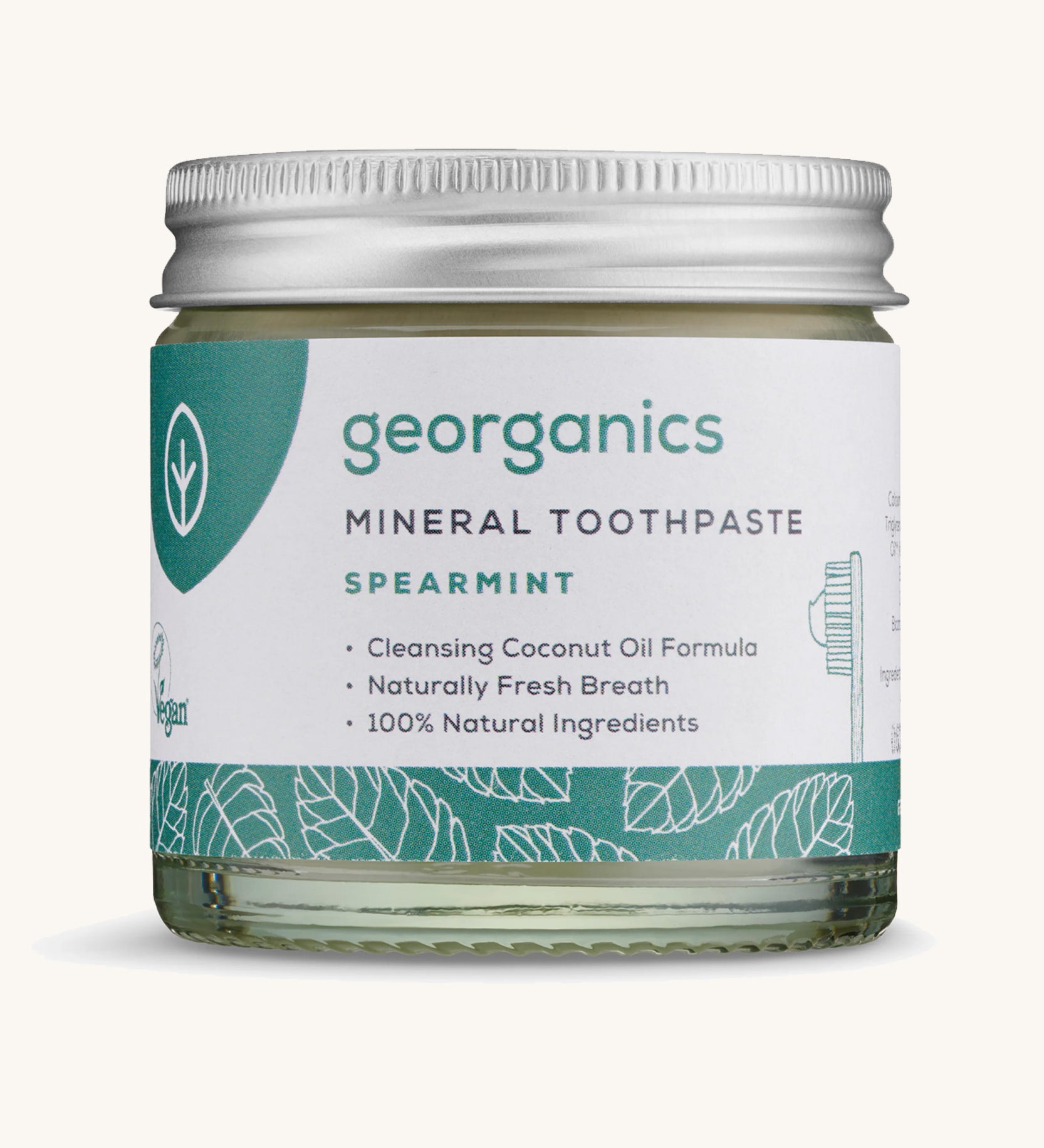 A jar of the Georganics spearmint mineral toothpaste on a cream background.