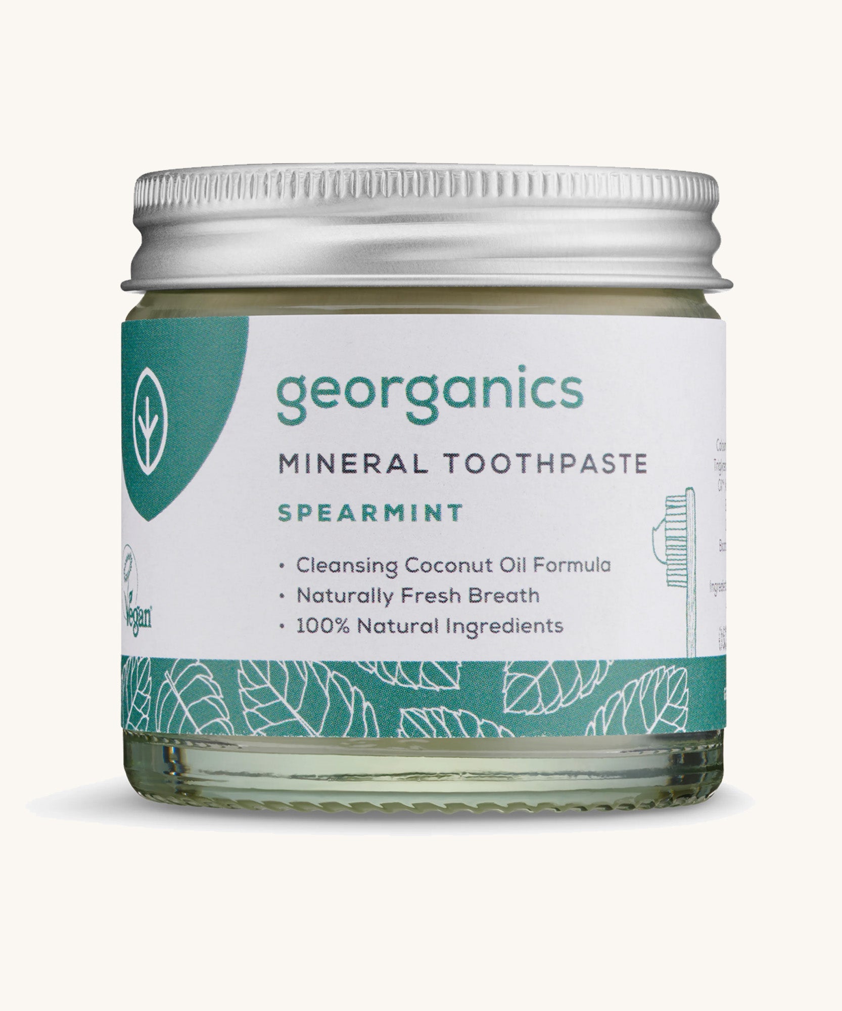 A jar of the Georganics spearmint mineral toothpaste on a cream background.