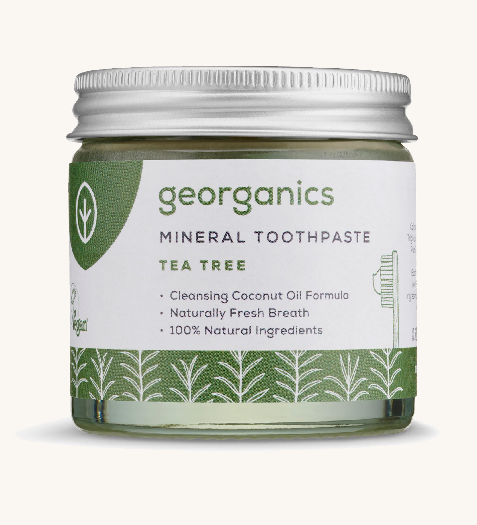 A jar of the Georganics tea tree mineral toothpaste on a cream background