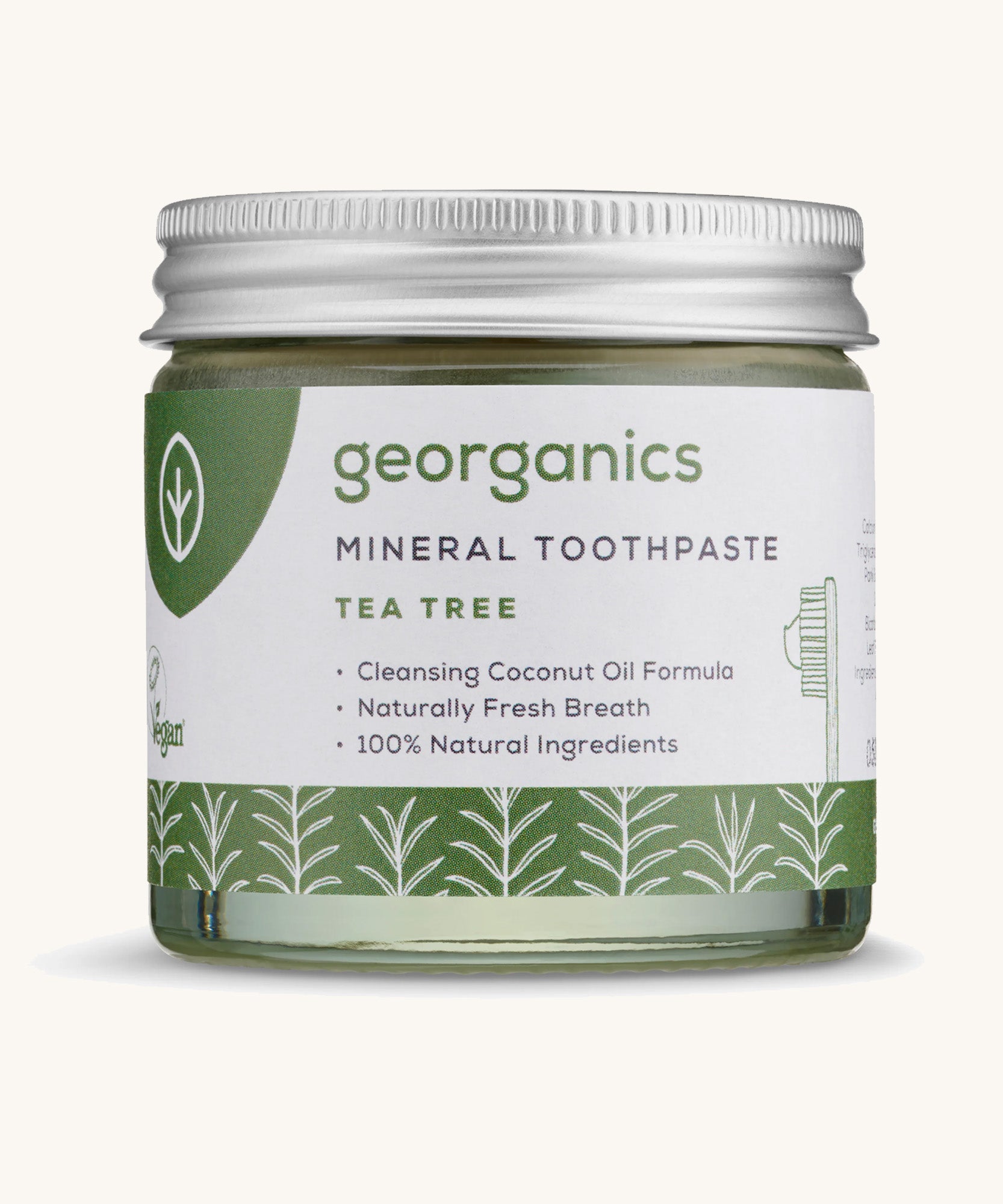 A jar of the Georganics tea tree mineral toothpaste on a cream background