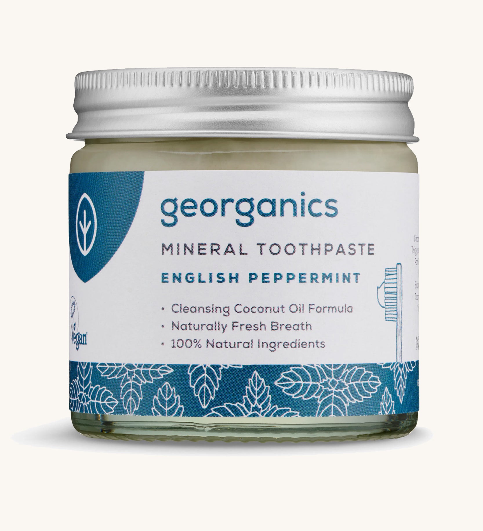 A jar of the Georganics English peppermint mineral toothpaste on a cream background.