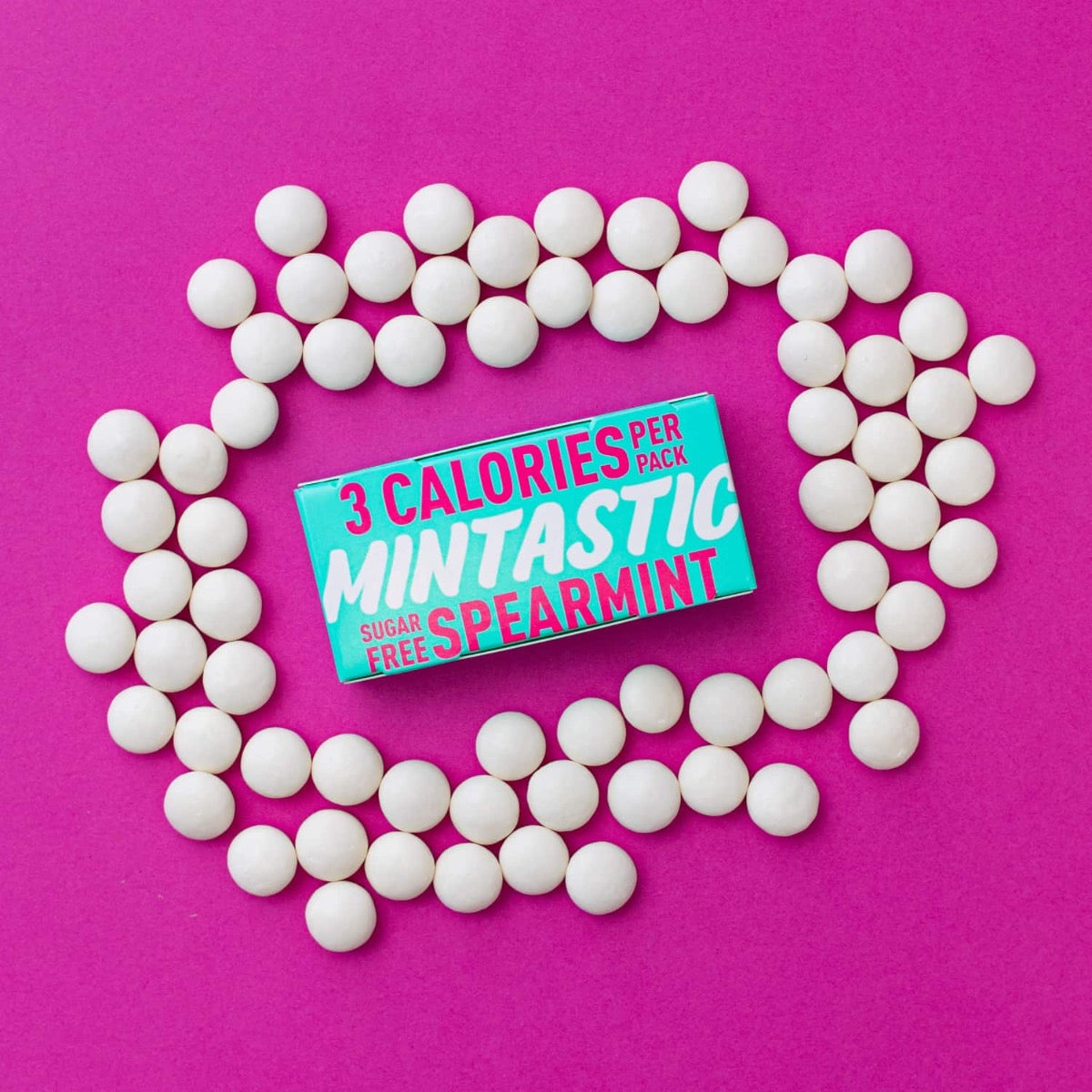 spearmint flavour in bright teal packaging with bright pink and white writing. On a white background